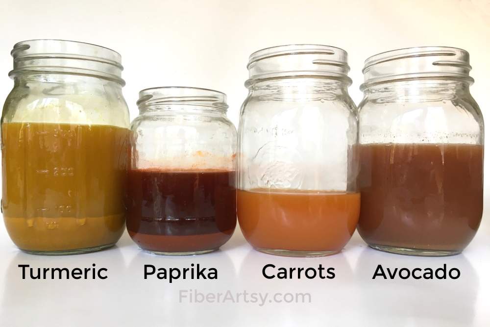 four mason jars with different colored liquid
